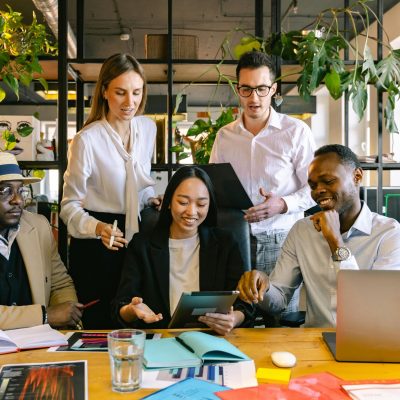 A group of diverse professionals working collaboratively in a modern office setting.